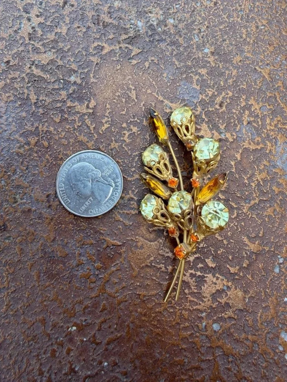 Vintage 1960s brooch with gold-tone metal and light green and orange rhinestones